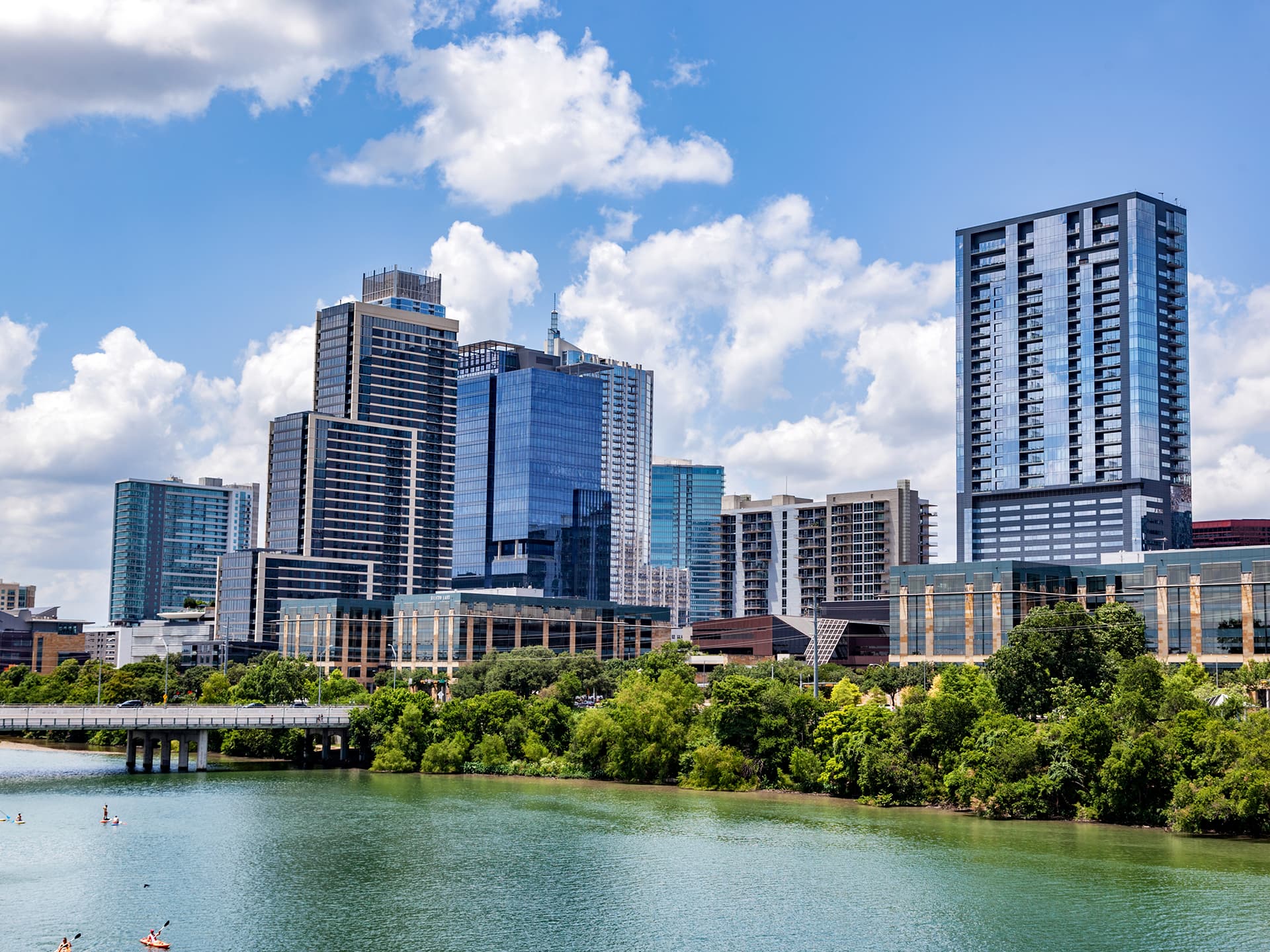 People working and smiling around a laptop